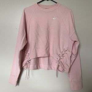Long sleeve cropped pink Nike pullover with laced stitching